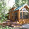 Cabin Park Model Cabin with Green Metal Roof and Side Patio Built on site