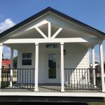 White Farmhouse Premier P577 with grey painted cabs, clerestory, and an optional island by Platinum Cottages. This custom built house was for an RRC Athens customer